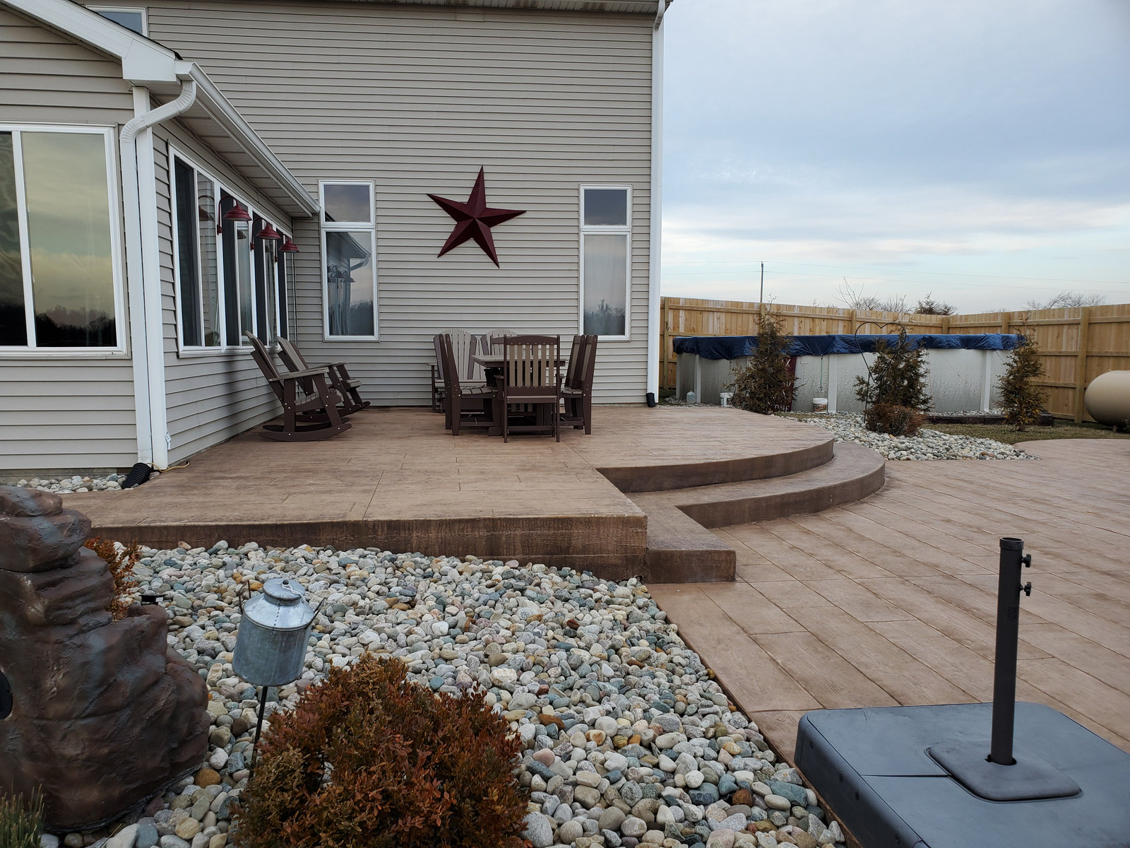 Stamped concrete patio with landscaping installed by a Northern Indiana patio contractor